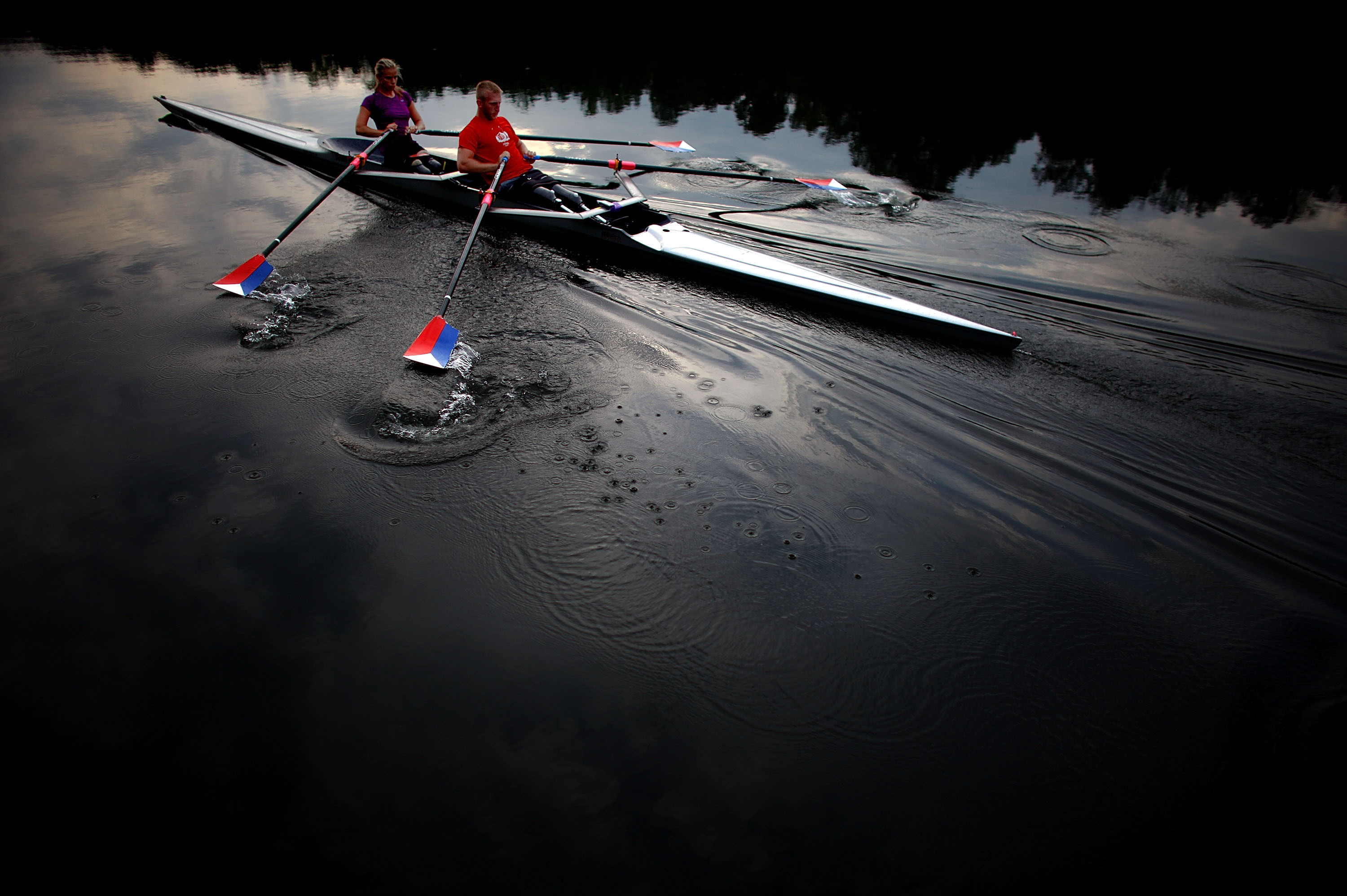 The teammates use a specially adapted rowing shell that is rigged with attachments so they can row comfortably, and slip in and out of the boat on their own.