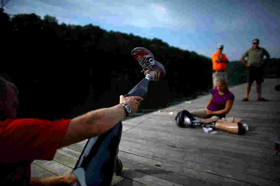 The athletes put on their prosthetic limbs after the training session.