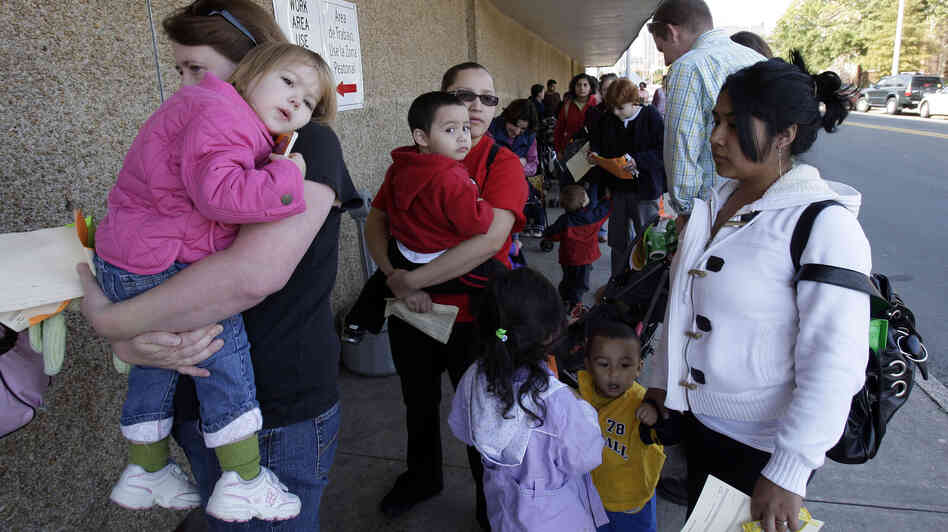 People wait in line at the Durham County Health Department for the H1N1 flu vaccination in Durham, N.C., in November 2009.