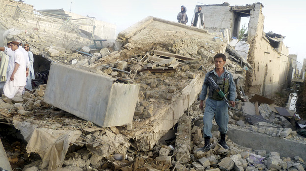 The aftermath of a truck bomb in Kandahar, the main city in southern Afghanistan, which wounded the provincial police chief and killed two civilians Monday. Taliban attacks against Afghan officials are up sharply this year.