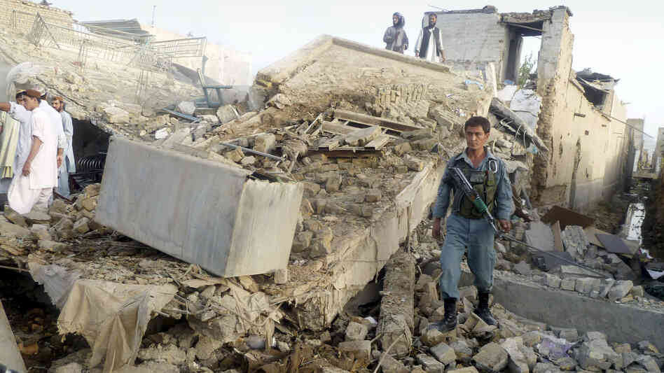 The aftermath of a truck bomb in Kandahar, the main city in southern Afghanistan, which wounded the provincial police chief and killed two civilians Monday. Taliban attacks against Afghan officials are up sharply this year.