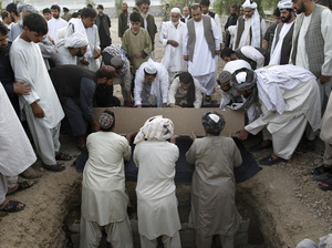 Afghans bury the mayor of  Kandahar, Ghulam Haidar Hamidi, after he was killed in a suicide bombing in July 2011. Afghan officials have extensive security but are still vulnerable to attack.