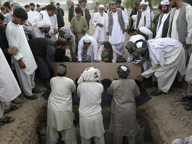 Afghans bury the mayor of  Kandahar, Ghulam Haidar Hamidi, after he was killed in a suicide bombing in July 2011. Afghan officials have extensive security but are still vulnerable to attack.