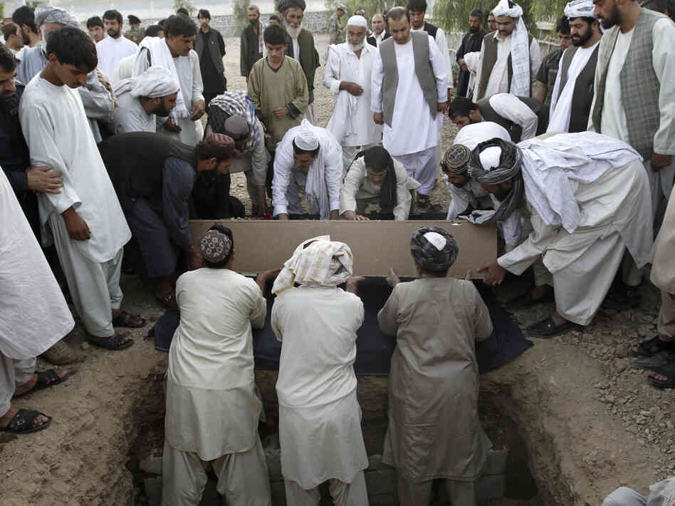 Afghans bury the mayor of  Kandahar, Ghulam Haidar Hamidi, after he was killed in a suicide bombing in July 2011. Afghan officials have extensive security but are still vulnerable to attack.
