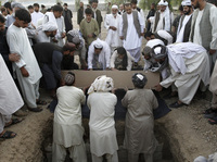 Afghans bury the mayor of Kandahar, Ghulam Haidar Hamidi, after he was killed in a suicide bombing in July 2011. Afghan officials have extensive security but are still vulnerable to attack.