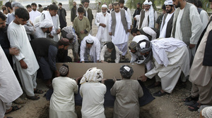 Afghans bury the mayor of Kandahar, Ghulam Haidar Hamidi, after he was killed in a suicide bombing in July 2011. Afghan officials have extensive security but are still vulnerable to attack.