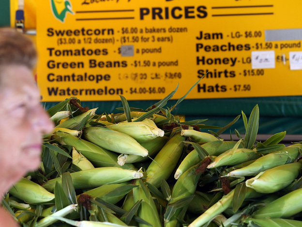 Grimes Sweetcorn worker Paulette Vandyke waits to sell fresh corn in Grimes, Iowa. The drought has pushed the price of corn per bushel up nearly 40 percent in the past two months.