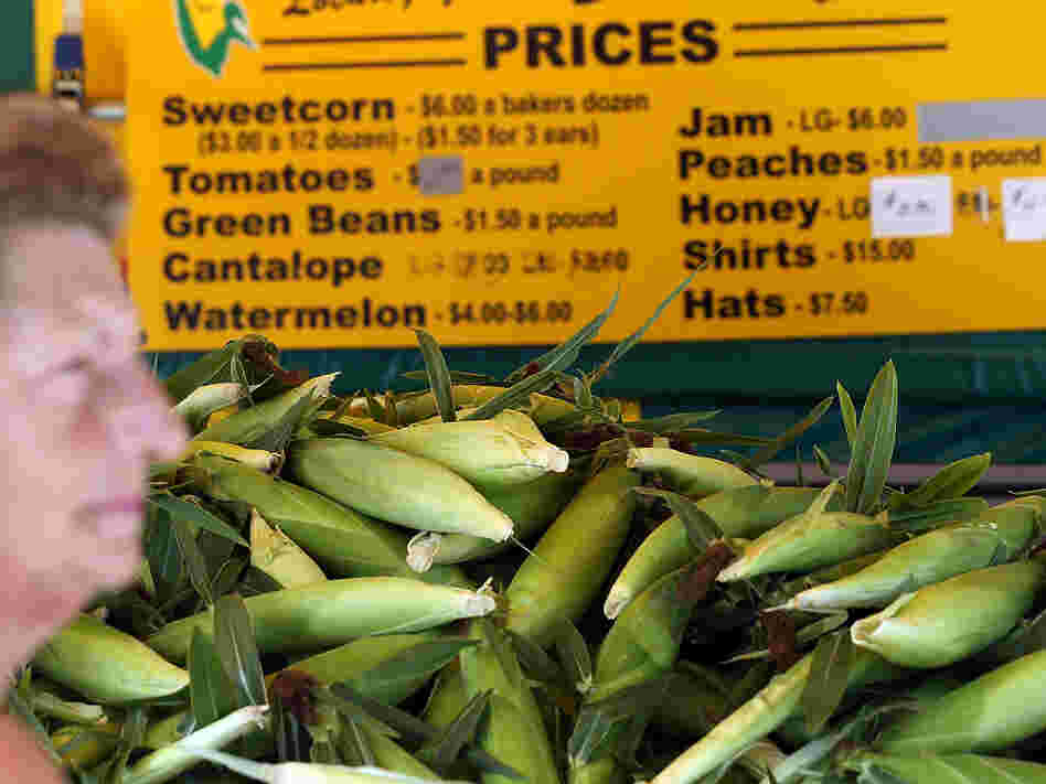 Grimes Sweetcorn worker Paulette Vandyke waits to sell fresh corn in Grimes, Iowa. The drought has pushed the price of corn per bushel up nearly 40 percent in the past two months.