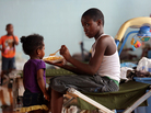 Darrell Hill, 11, feeds his sister Floy Dillon, 2, at a flood shelter in a school gym in Kentwood, La., Thursday. Residents fled to the shelter after officials announced that a dam upstream in Mississippi was in danger of bursting. Darrell Hill, 11, feeds his sister Floy Dillon, 2, at a flood shelter in a school gym in Kentwood, La., Thursday. Residents fled to the shelter after officials announced that a dam upstream in Mississippi was in danger of bursting.