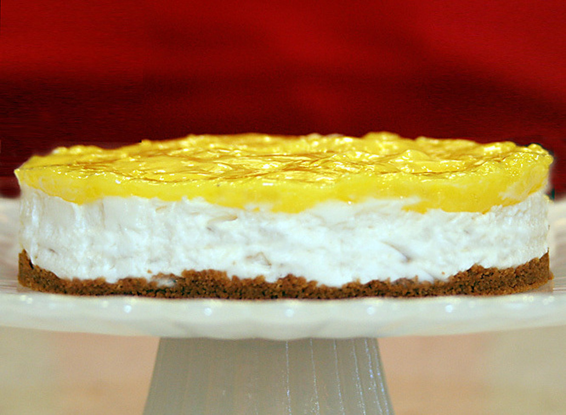 A Lemon Icebox Cheesecake on a cake stand