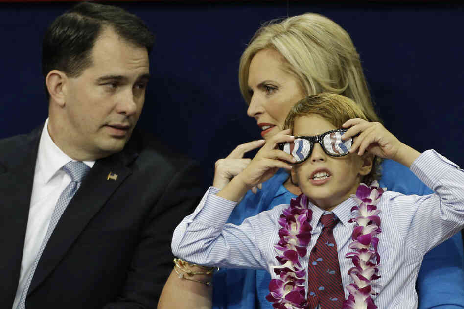 Ann Romney, wife of GOP presidential nominee Mitt Romney, talks to Wisconsin Gov. Scott Walker with one of her grandsons sitting on her lap.
