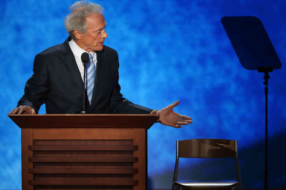 Actor and filmmaker Clint Eastwood gestures to an empty chair, pretending President Obama is sitting onstage, during his speech.