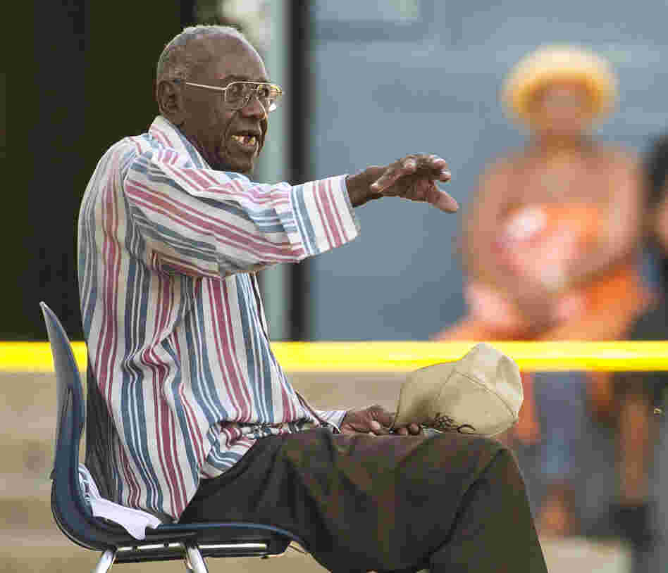 Senior driver Preston Carter, 100, talks with police officers after police say his car went onto a sidewalk and plowed into a group of parents and children outside a South Los Angeles elementary school on Wednesday.