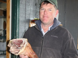 Mark Baker produces cured pork from a type of hybrid swine recently put on Michigan's invasive species list. Baker says complying with the state's new rules will end his business.