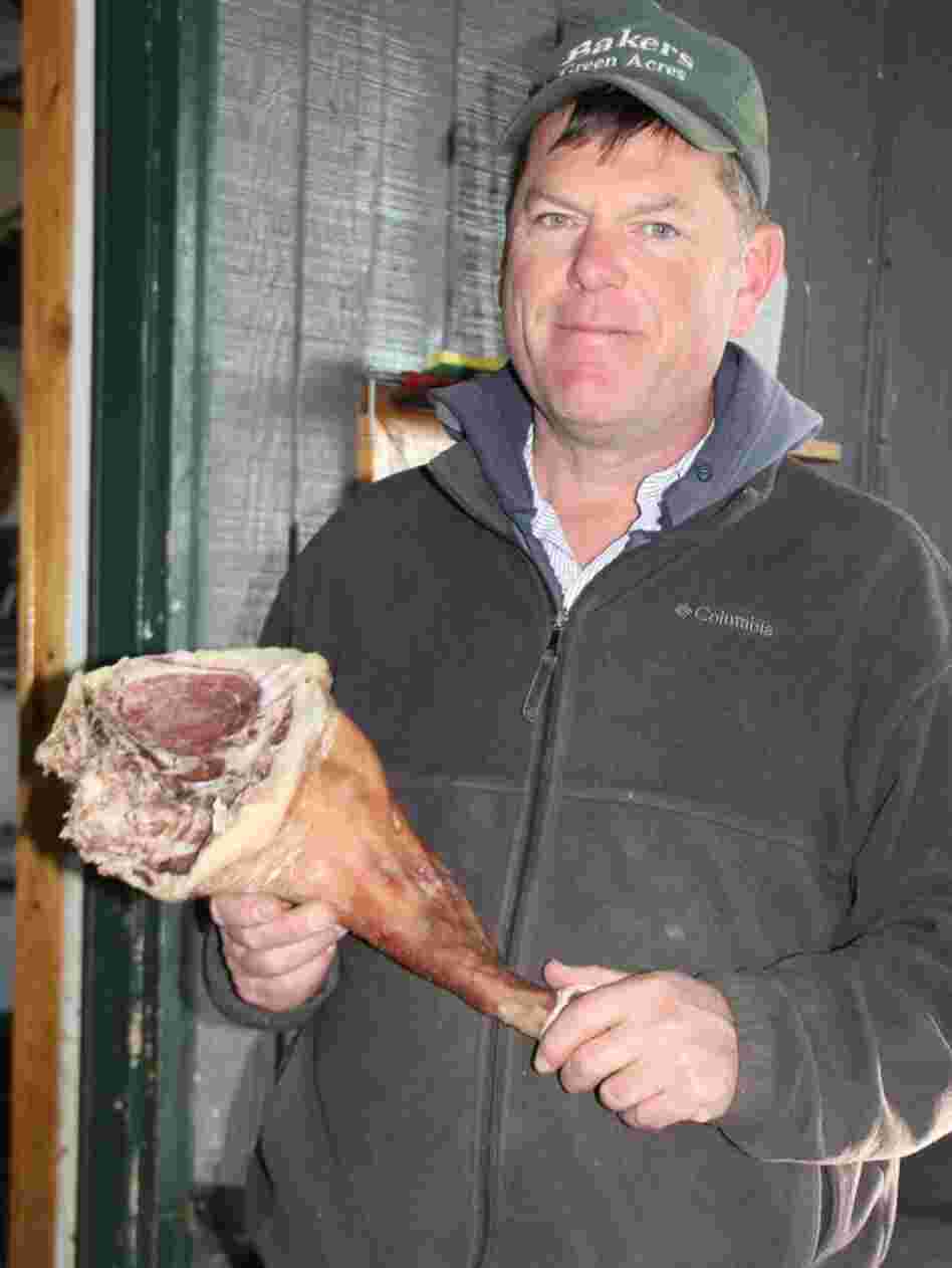 Mark Baker produces cured pork from a type of hybrid swine recently put on Michigan's invasive species list. Baker says complying with the state's new rules will end his business.