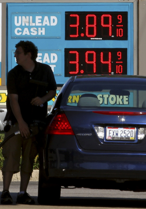 A man fills his gas tank Wednesday in Lyndhurst, Ohio. Gas prices surged as Isaac approached, but are expected to ease after Labor Day.