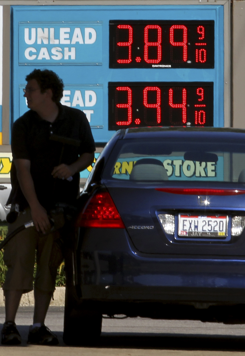 A man fills his gas tank Wednesday in Lyndhurst, Ohio. Gas prices surged as Isaac approached, but are expected to ease after Labor Day.