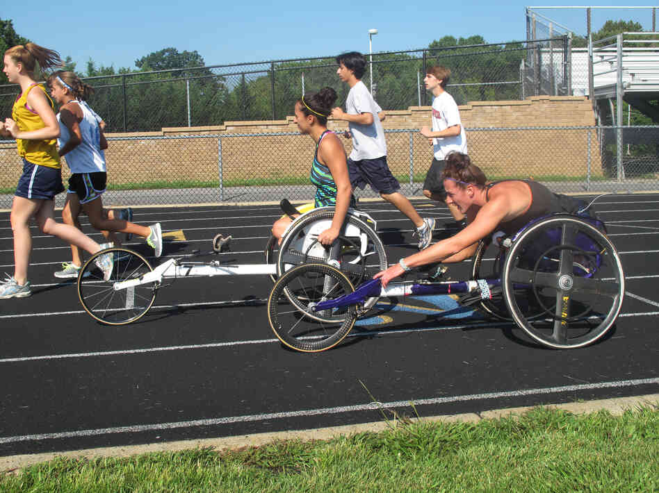 Tatyana McFadden (front), and her sister Hannah practice for the Paralympics on a high school track in Columbia, Md.