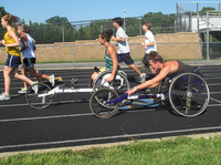 Tatyana McFadden (front), and her sister Hannah practice for the Paralympics on a high school track in Columbia, Md.