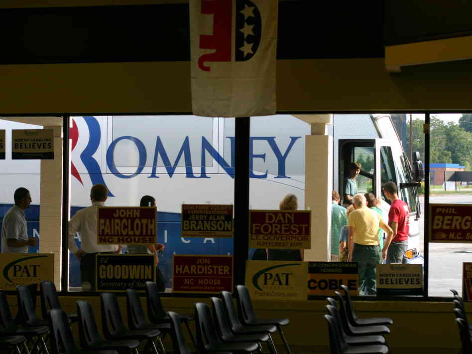 Romney supporters line up to tour the campaign bus.