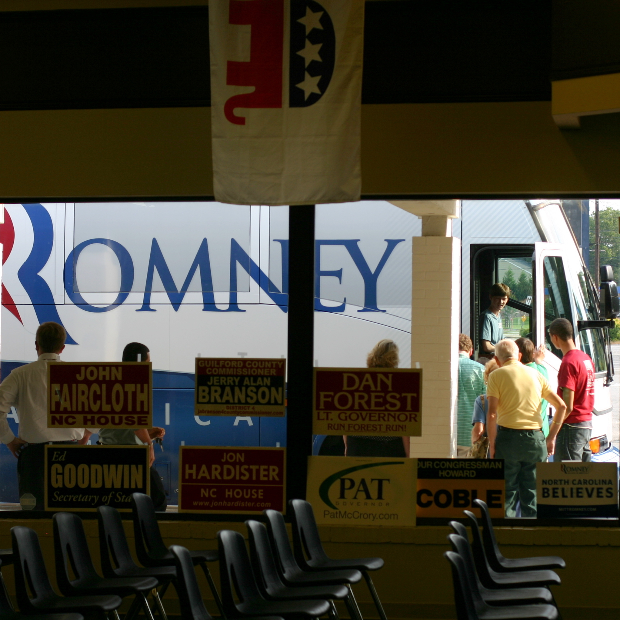 Romney supporters line up to tour the campaign bus.
