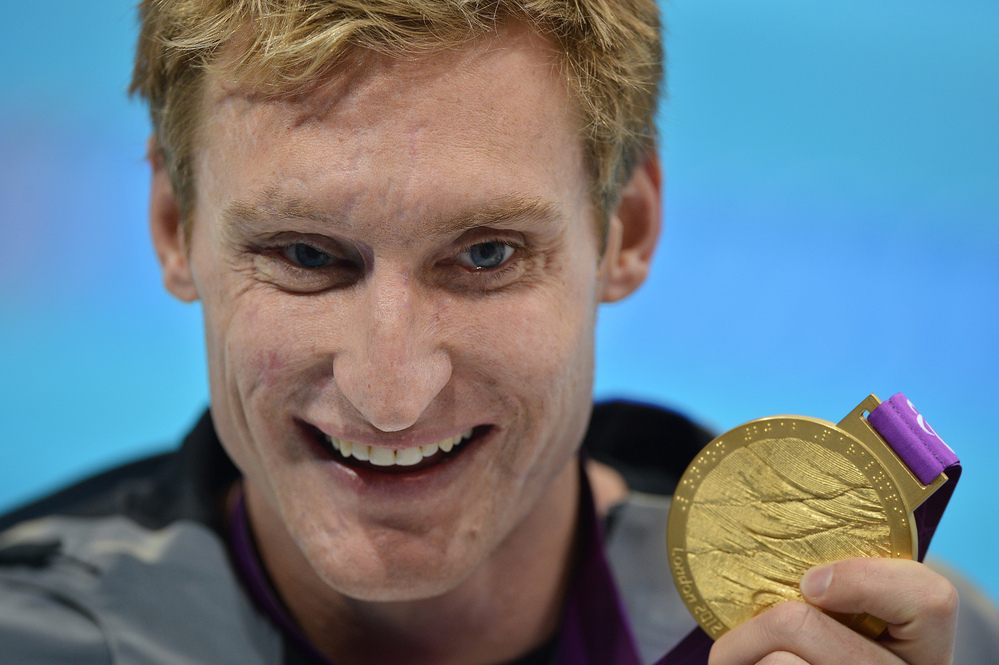 U.S. swimmer Bradley Snyder poses with his gold medal after winning the men's 100m freestyle - S11 final at the London 2012 Paralympic Games.