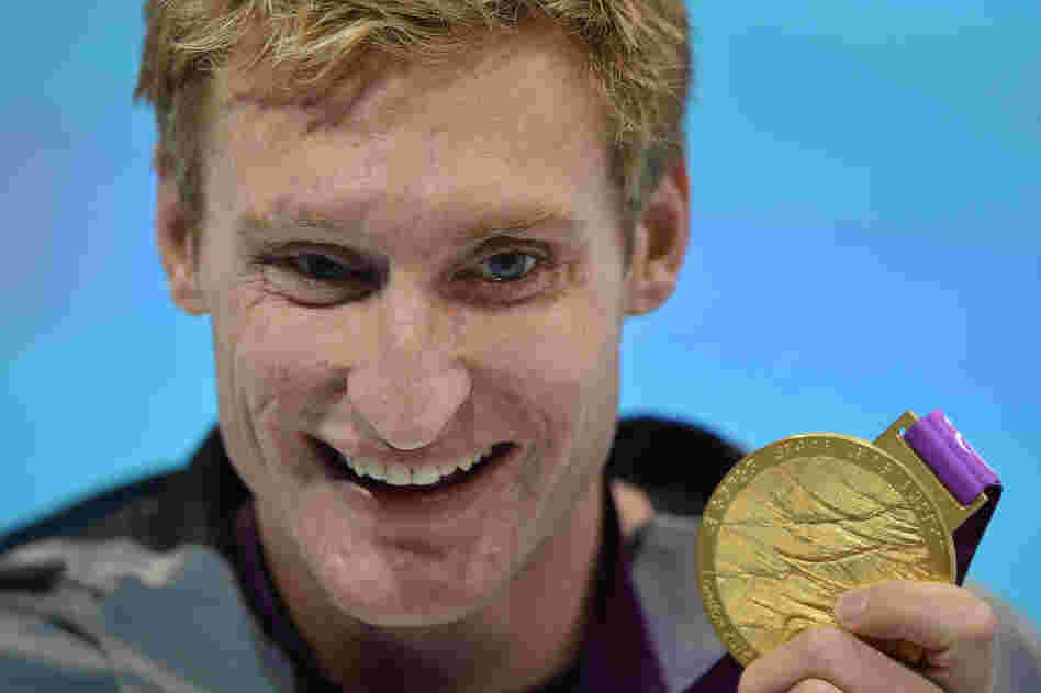 U.S. swimmer Bradley Snyder poses with his gold medal after winning the men's 100m freestyle - S11 final at the London 2012 Paralympic Games.