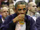 President Obama drinks a beer — that's presumably not from the White House — as he watches the U.S. men's basketball team play Brazil in an Olympic exhibition game in July. President Obama drinks a beer — that's presumably not from the White House — as he watches the U.S. men's basketball team play Brazil in an Olympic exhibition game in July.