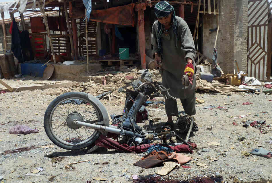 An Afghan man inspects a motorcycle used in a suicide attack in a parking lot holding dozens of trucks supplying the NATO-run Kandahar Air Base in June. Bombings and assassinations are on the rise in Kandahar. Last month, a suicide bomber struck the convoy of the provincial police chief, Gen. Abdul Raziq, who was severely injured. An Afghan man inspects a motorcycle used in a suicide attack in a parking lot holding dozens of trucks supplying the NATO-run Kandahar Air Base in June. Bombings and assassinations are on the rise in Kandahar. Last month, a suicide bomber struck the convoy of the provincial police chief, Gen. Abdul Raziq, who was severely injured.