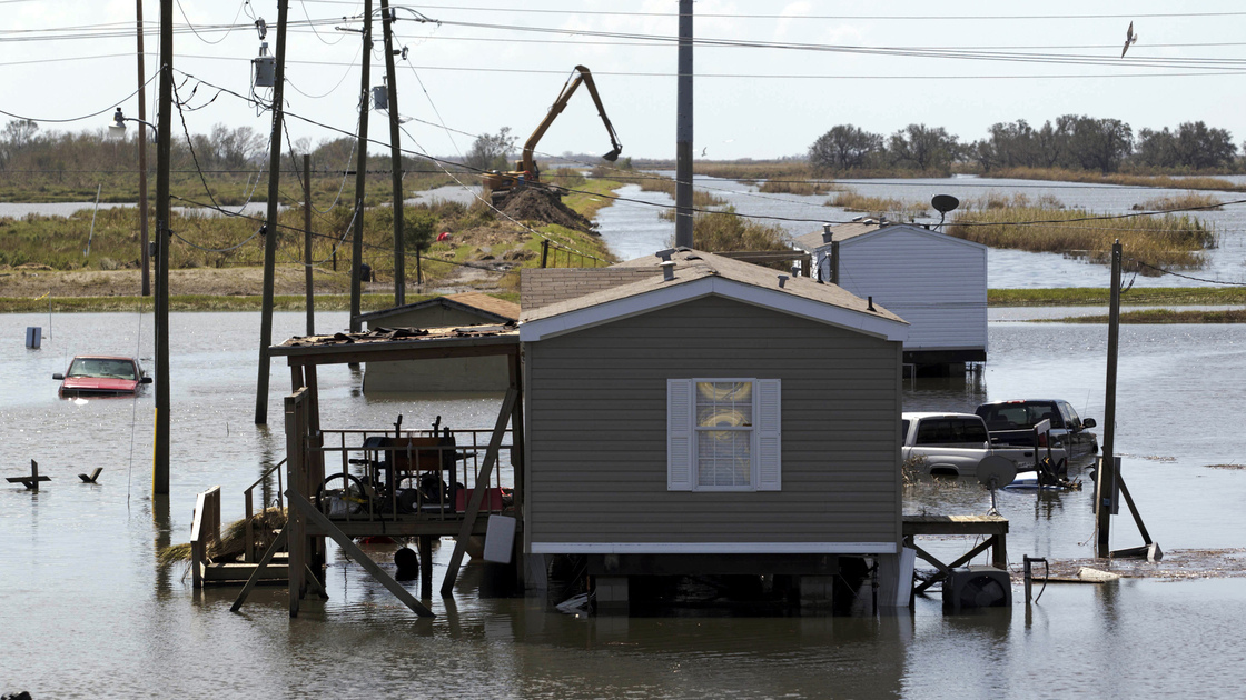 Trucks are flooded in receding flood waters from Hurricane Isaac along Louisiana Hwy 23 near West Point a La Hache, La., in Plaquemines Parish Monday.