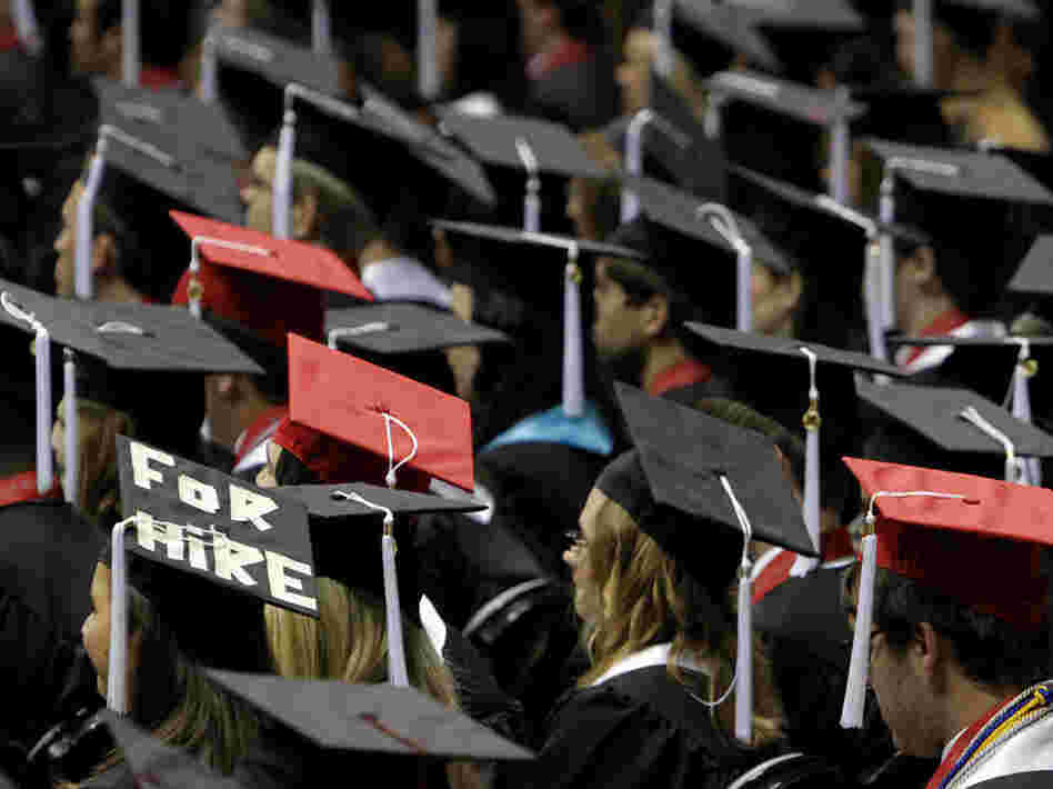 Graduates attend a ceremony at the University of Alabama in Tuscaloosa. Writer Joel Kotkin notes that many recent college grads are saddled with high debt and dim job prospects. Graduates attend a ceremony at the University of Alabama in Tuscaloosa. Writer Joel Kotkin notes that many recent college grads are saddled with high debt and dim job prospects.