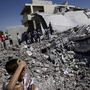 Syrians gather by the rubble of a house destroyed by shelling in the northern town of Azaz, on the outskirts of Aleppo, on Monday. Syrians gather by the rubble of a house destroyed by shelling in the northern town of Azaz, on the outskirts of Aleppo, on Monday.