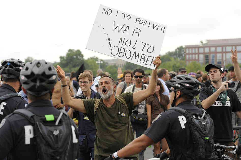 Protesters attempt to march outside their designated areas, but are stopped by police.