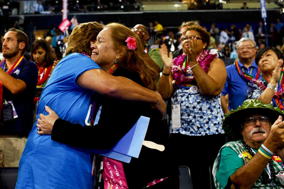 Delegates from Hawaii applaud and hug after the speech of Mary Kay Henry, president of the Service Employees International Union.