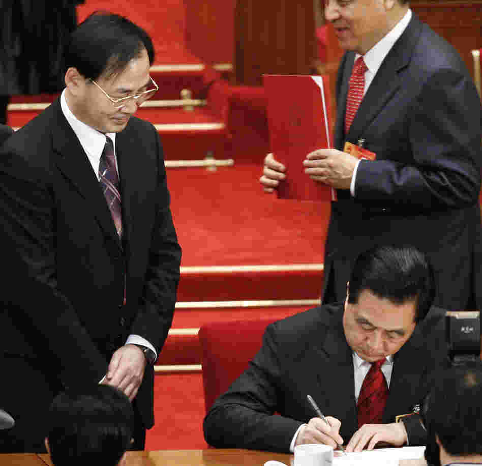 Ling Jihua, left, looked on in March 2010 as Chinese President Hu Jintao, signed a document at the closing ceremony of the National People's Congress in Beijing. Ling has been shifted to a lesser position.