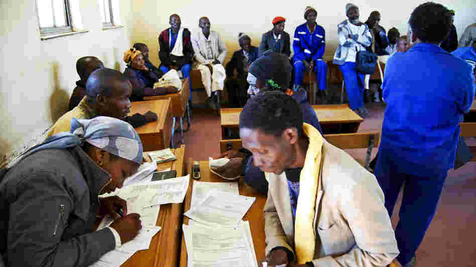 A team of paralegals interview former miners in a primary school in Bizana, in South Africa's rural Eastern Cape province. The legal team is screening miners to see if they have lung disease. It's part of a class-action lawsuit against South African gold mining companies.