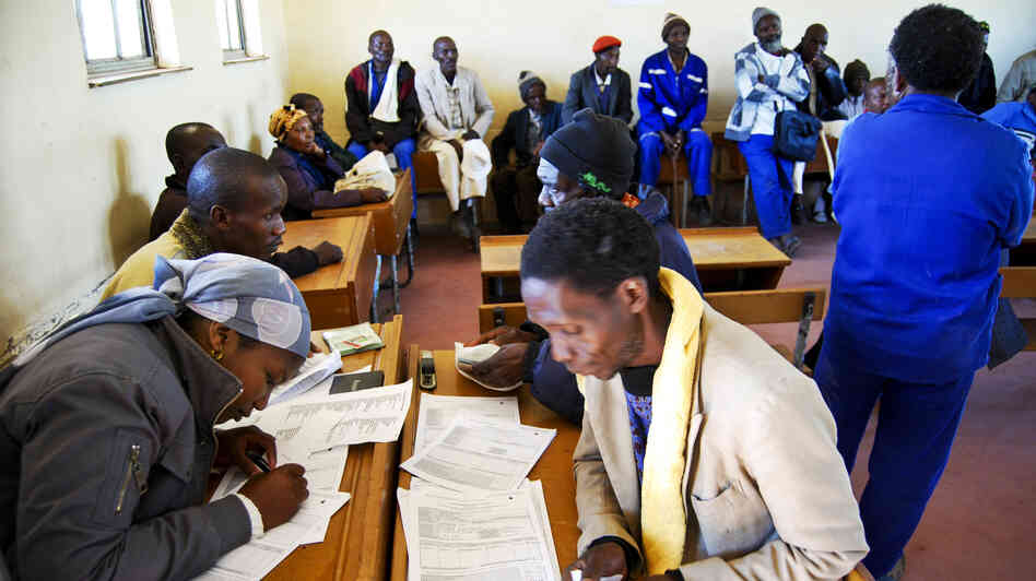 A team of paralegals interview former miners in a primary school in Bizana, in South Africa's rural Eastern Cape province. The legal team is screening miners to see if they have lung disease. It's part of a class-action lawsuit against South African gold mining companies.
