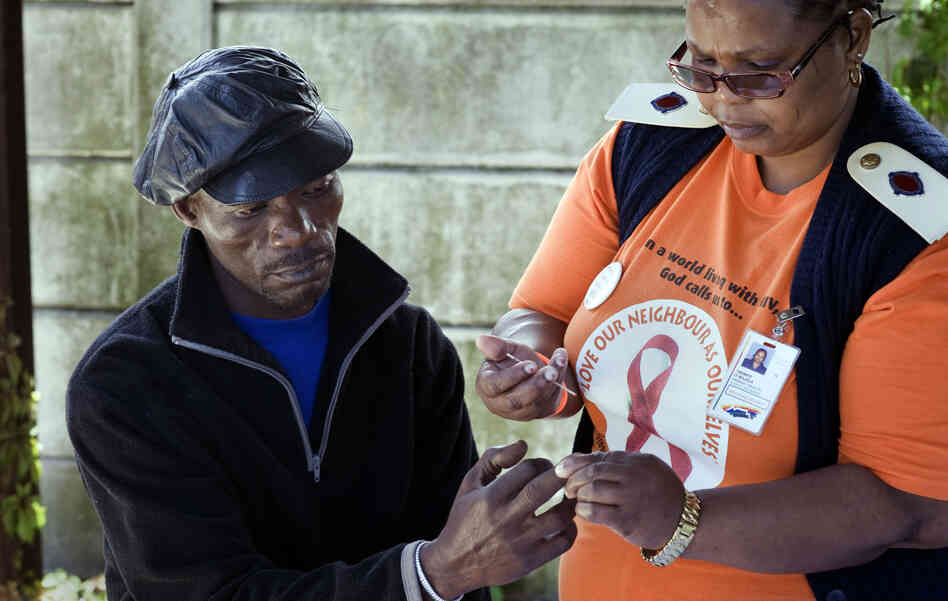 Nurse Irena Majola tests Justice Mlambo's blood for HIV at a roadside AIDS testing table in a suburb near Cape Town. Under the "test and treat" strategy, about 45 million South Africans would need to be screened for HIV each year. Nurse Irena Majola tests Justice Mlambo's blood for HIV at a roadside AIDS testing table in a suburb near Cape Town. Under the "test and treat" strategy, about 45 million South Africans would need to be screened for HIV each year.