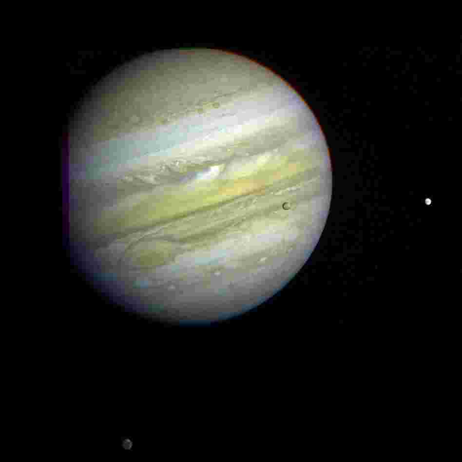 As Voyager 1 passed by Jupiter on Feb. 5, 1979, it captured this image of the planet and its Great Red Spot, as well as three of its four largest moons — Io, Europa and Callisto.