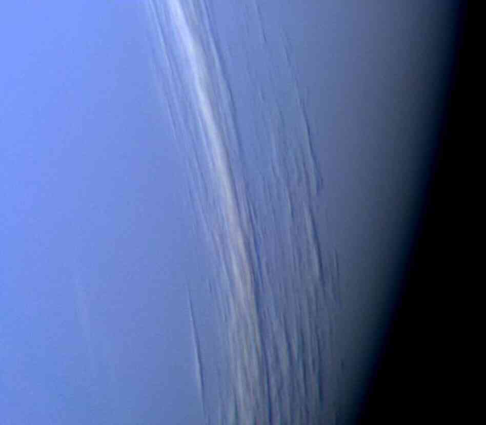 About three years later, in 1989, Voyager 2 reached Neptune, where it captured this high-resolution color image, which shows bright cloud streaks on the planet.