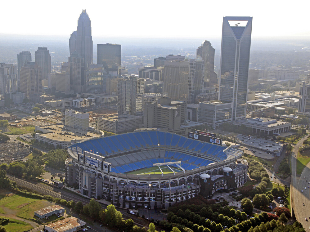 The skyline of Charlotte, N.C., rises behind Bank of America Stadium.