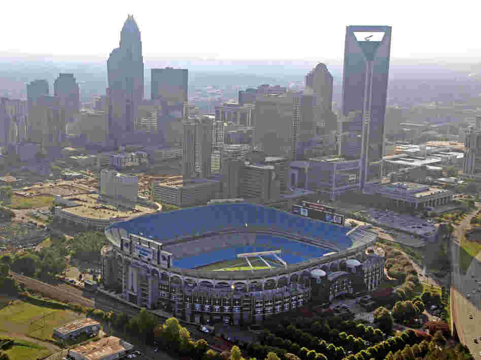 The skyline of Charlotte, N.C., rises behind Bank of America Stadium.