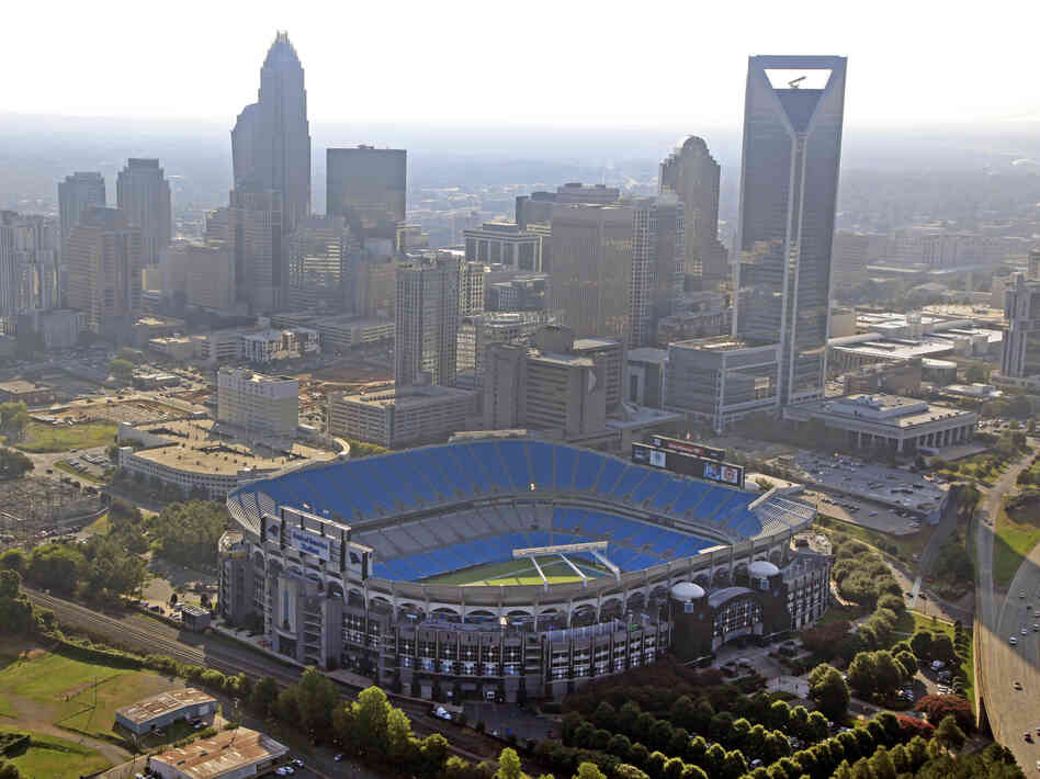 The skyline of Charlotte, N.C., rises behind Bank of America Stadium.