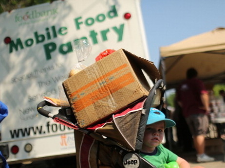 In Oswego, N.Y., this summer, a child waited at a food distribution site. In Oswego, N.Y., this summer, a child waited at a food distribution site.