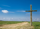 Old wooden cross on a country road. Old wooden cross on a country road.