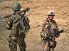 A U.S. Marine (right) and an Afghan National Army soldier on patrol this summer in Afghanistan's Helmand Province.