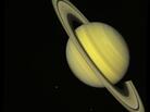 The two Voyager spacecraft launched on Aug. 20 and Sept. 5, 1977, on a mission to explore Jupiter and Saturn. This true-color image, captured by Voyager 2 on July 21, 1981, shows the moons Dione (small dot at left) and Rhea (lower right) near Saturn. The two Voyager spacecraft launched on Aug. 20 and Sept. 5, 1977, on a mission to explore Jupiter and Saturn. This true-color image, captured by Voyager 2 on July 21, 1981, shows the moons Dione (small dot at left) and Rhea (lower right) near Saturn.