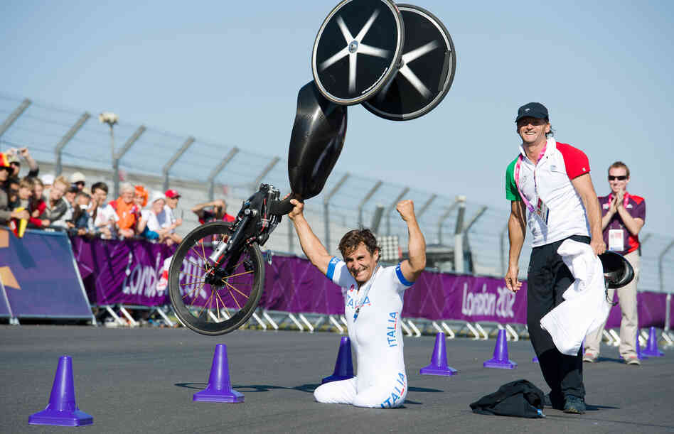 Alex Zanardi celebrates winning the gold medal in the men's individual H4 time trial cycling final at the London 2012 Paralympic Games at Brands Hatch circuit, in Kent, southern England. Zanardi's legs were amputated after a racecar crash in 2001.