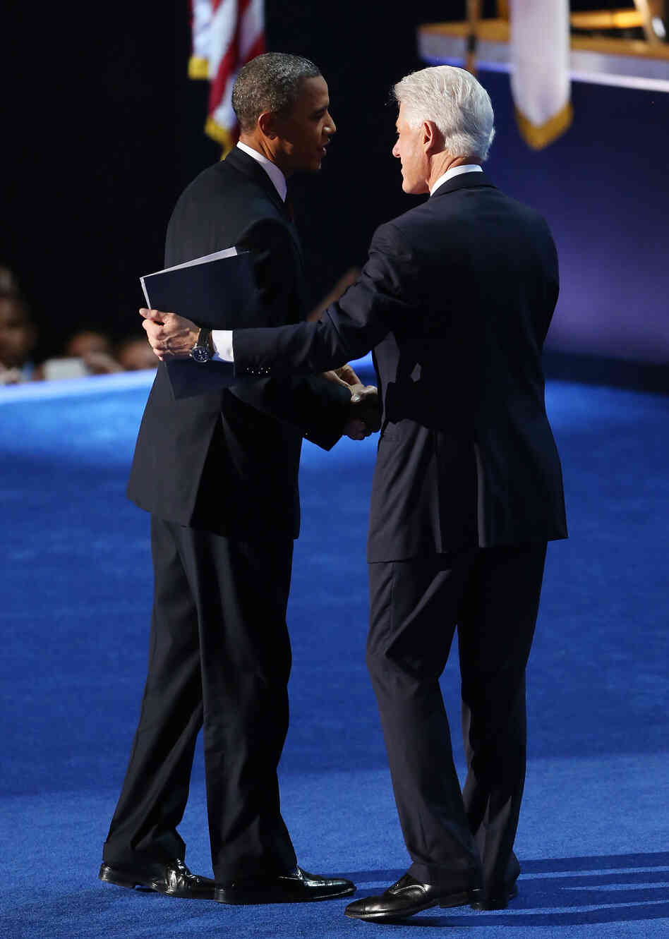 President Obama greets former President Bill Clinton onstage at the Democratic National Convention. President Obama greets former President Bill Clinton onstage at the Democratic National Convention.