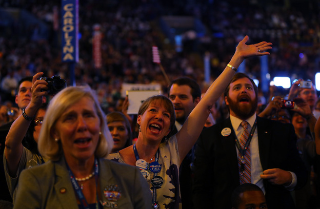 Attendees sing and dance as musician James Taylor performs onstage during the final day of the Democratic National Convention at Time Warner Cable Arena on Thursday.
